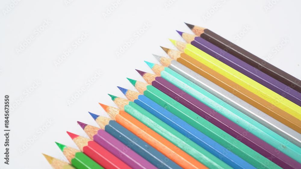 Fototapeta premium A collection of colorful drawing pencils on a clean white surface for art and education.