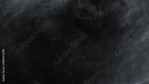 A heavy, dense cloud of white smoke or fog rolls slowly from the top left corner, creating a thick, atmospheric texture on a black background