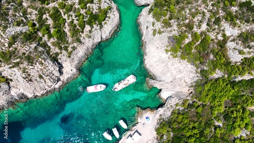 Aerial drone cinematic video of tropical exotic seascape ideal for snorkeling with sea caves and white limestone rocks resembling a blue lagoon