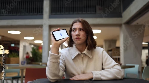 ChatGPT confuses young woman as she listens to strange response holding phone and freezing in uncertainty during awkward conversation and emotional hesitation