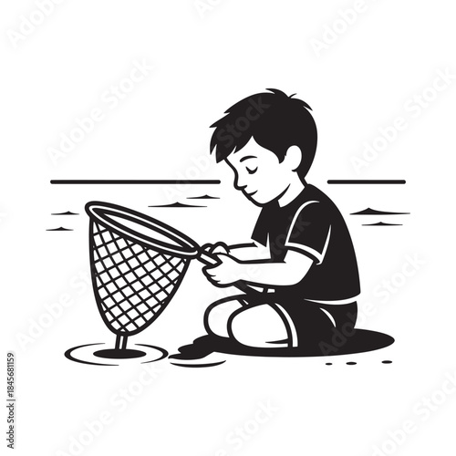 A young boy attentively attempts to catch something with a net by the water