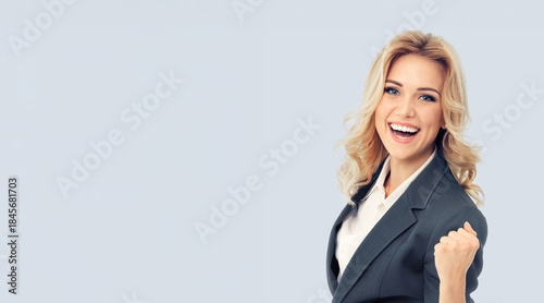 Wow! Portrait image of expressive emotional smiling businesswoman business woman wear grey corporate formal suit jacket. Happy cute blond hair girl, isolated gray background with free ad text space