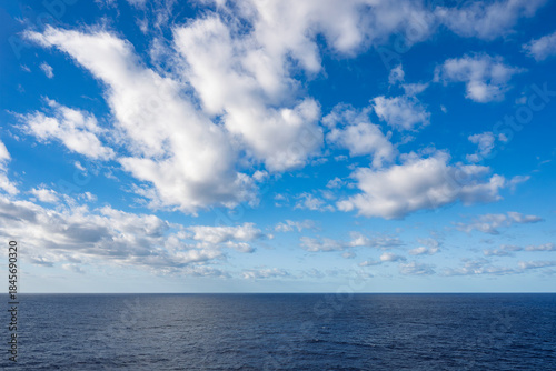 Fluffy clouds, brilliant blue sky, and crystal clear Caribbean waters