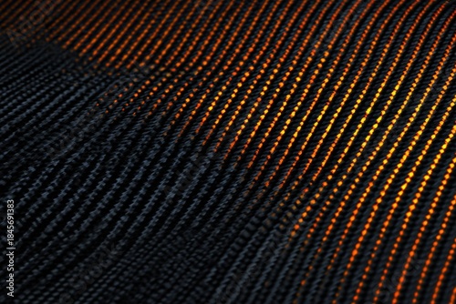Carbon Fiber Texture: Close-up shot showcases a high-tech material with a mesmerizing woven pattern. The dark surface gleams with subtle hints of gold or amber.