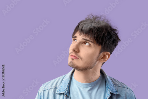 Sad young man with graying ...
