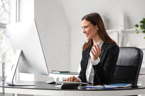 Beautiful businesswoman working with computer at desk in office