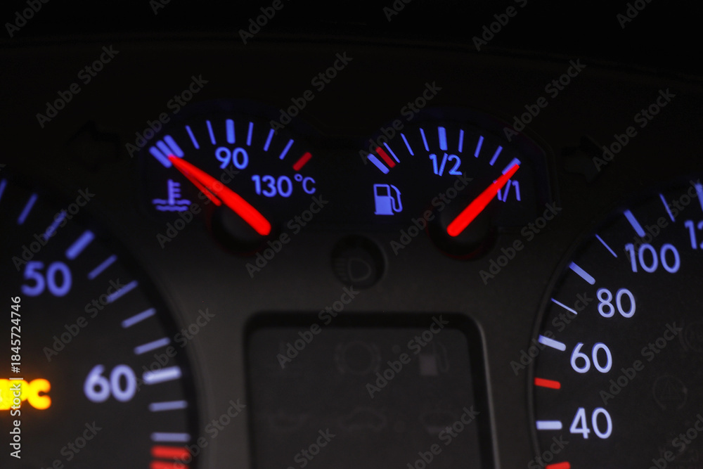 Fototapeta premium Car dashboard with fuel and engine temperature gauges, closeup