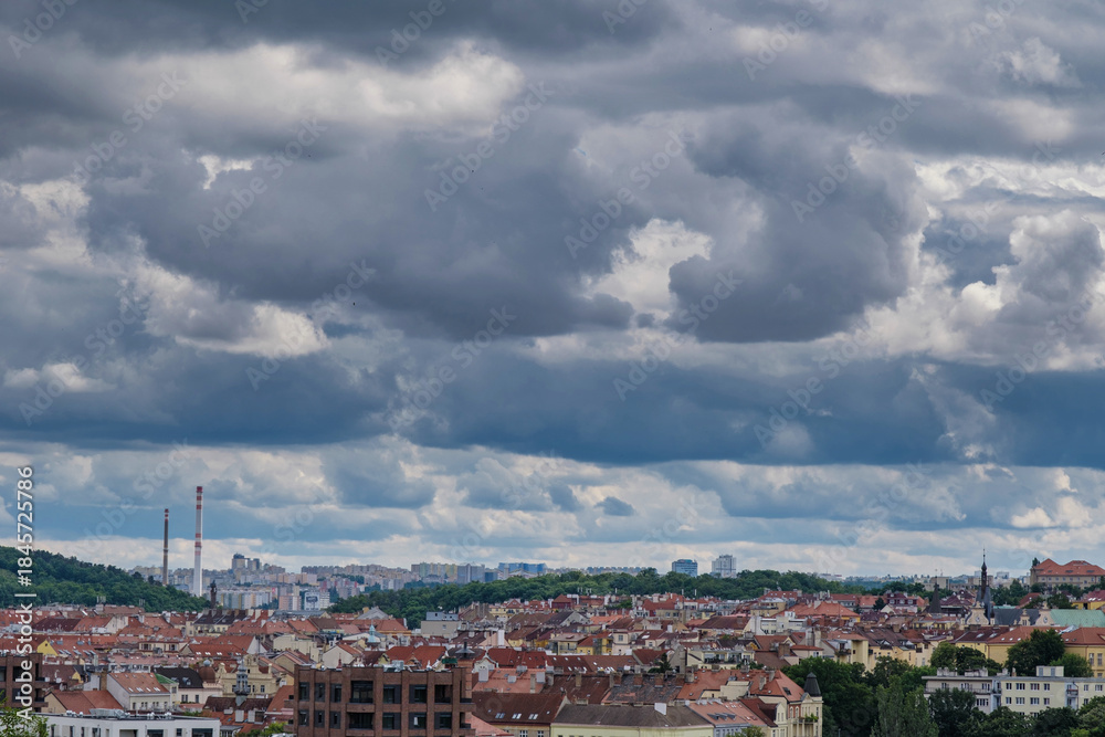 Fototapeta premium Breathtaking panoramic view of Prague, showcasing its historic city center with iconic buildings, charming red-roofed houses.