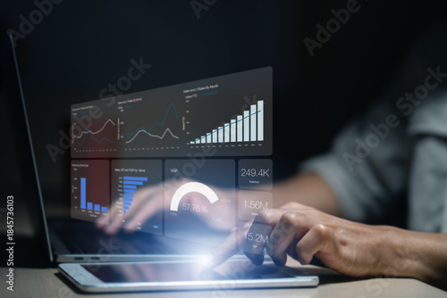 Man is using a laptop to analyze and track sales growth, comparing year-on-year sales. business dashboard interface with analytics widgets including charts, graphs, and statistics.