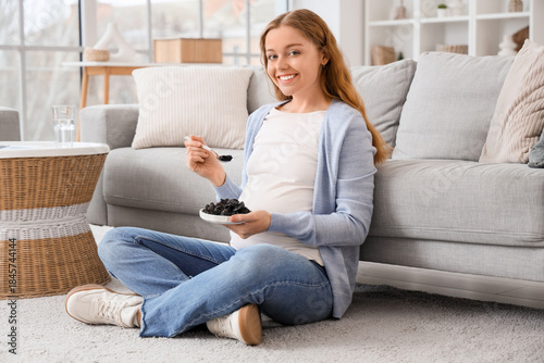 Young pregnant woman with d...