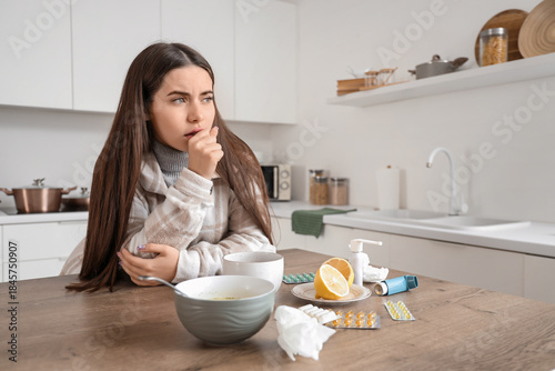 Ill young woman in kitchen