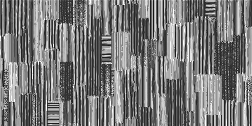 Abstract pattern of vertical and horizontal white lines on a dark gray background creating textured blocks