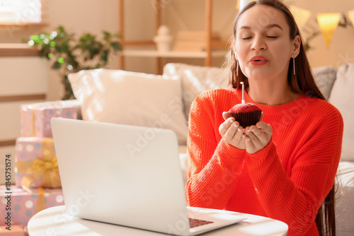Young woman with muffin and...