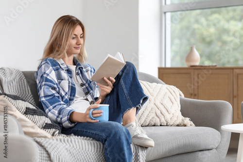 Young woman with cup of tea...