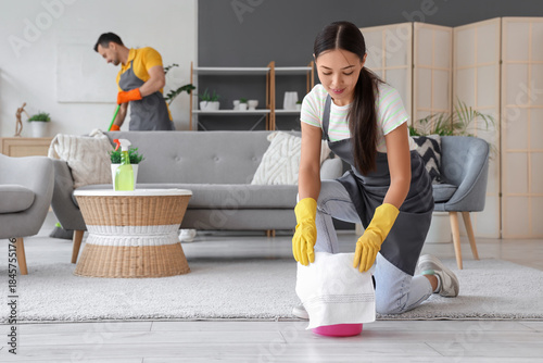 Female Asian janitor with b...