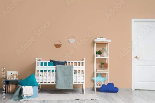Stylish crib with plaid and...