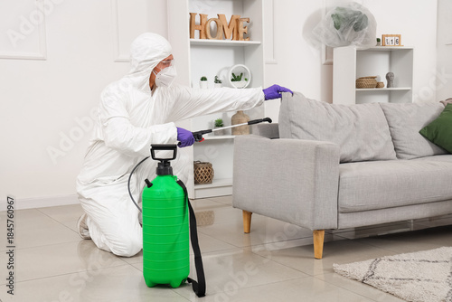 Male worker disinfecting so...