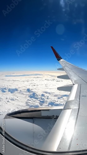 Airplane Wing Flying Over Clouds on a Sunny Day