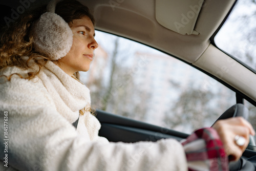 Woman drives car with warmth and focus