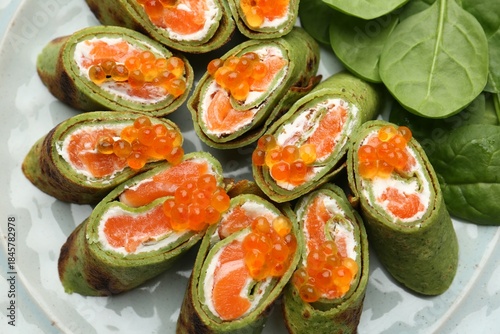 Wallpaper Mural Tasty spinach crepes with salmon, cream cheese, red caviar and leaves on plate, top view Torontodigital.ca