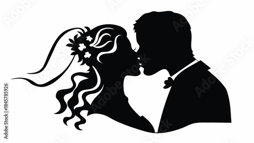 Romantic wedding couple sharing tender kiss in elegant silhouette