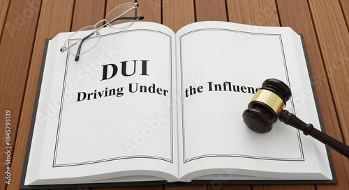 Legal book about DUI laws and consequences, with gavel and glasses on wooden table