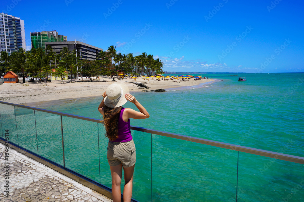 Obraz premium Holidays in Brazil. Back view of young woman enjoying viewpoint on belvedere in Maceio, Alagoas, Brazil.