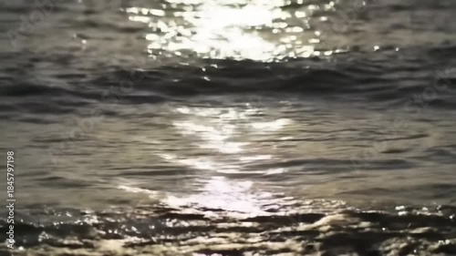 Sunlight reflecting on water creating bright bokeh at the beach