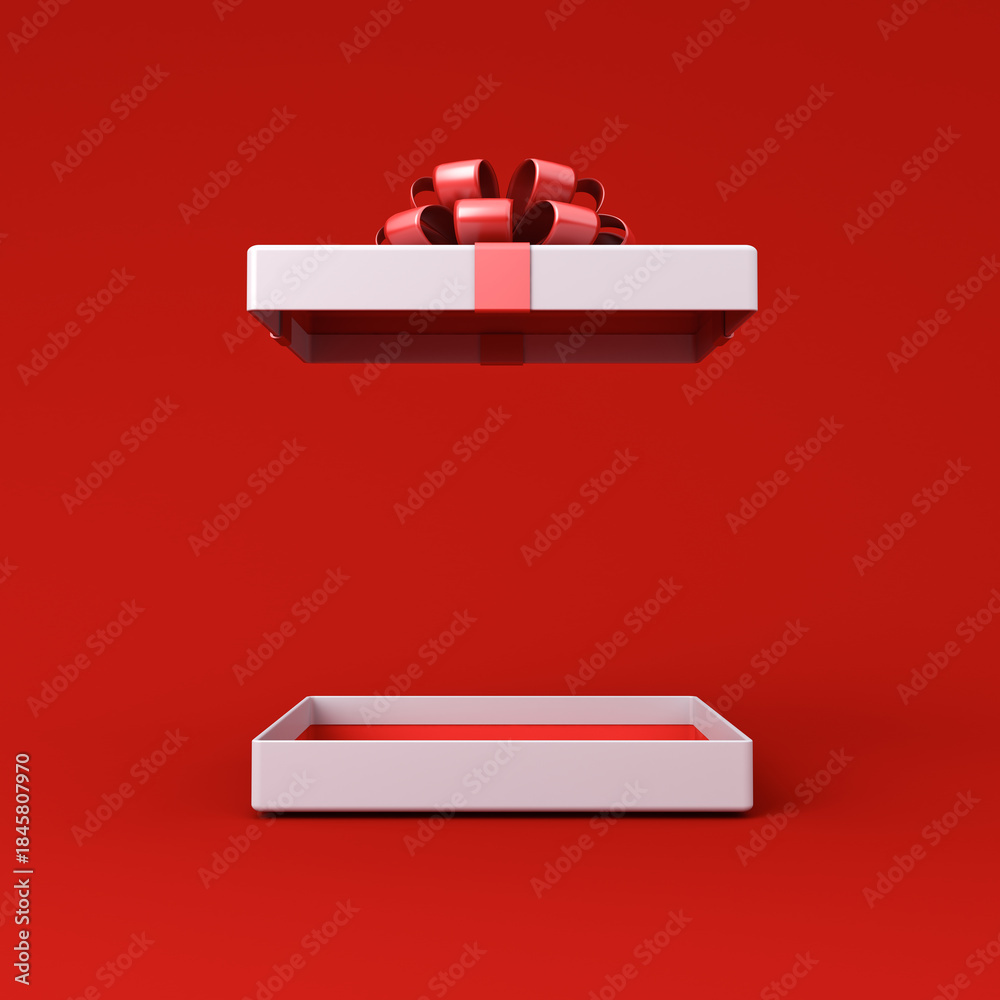 Obraz premium Blank low white present box open with red inside product display mock up showcase or blank red gift box with red ribbon bow isolated on red background with shadow creative idea concepts 3D rendering