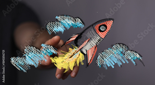 Hand holding a rocket takin...