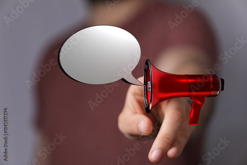 A hand holding a red megaph...