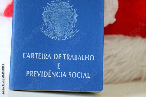 Fotografi Brazilian Work Card (Carteira de Trabalho do Brasil) and Santa Claus hat, symbolizing seasonal job opportunities during the Christmas holiday season