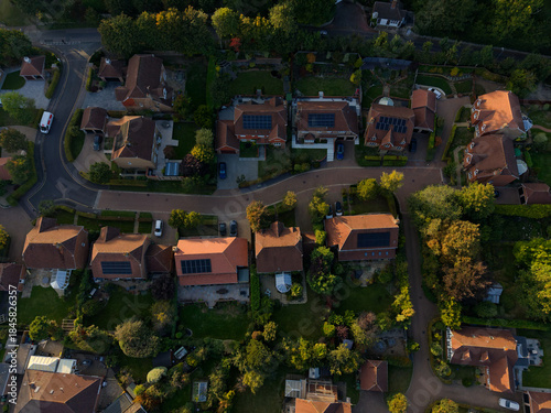 Obraz na plátně Aerial view of rooftops and solar panels at sunset