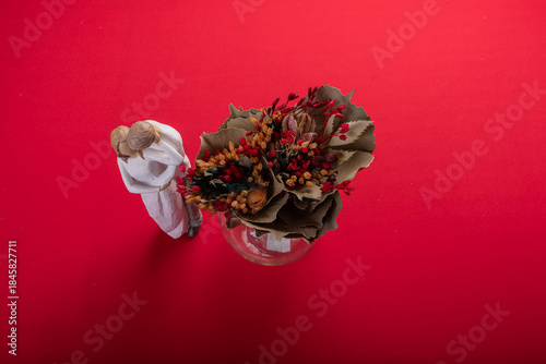 Minimal floral arrangement on red surface