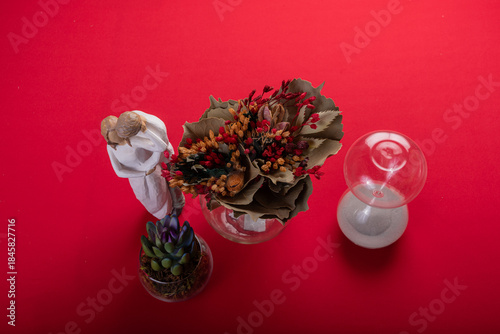 Minimal floral arrangement on red surface