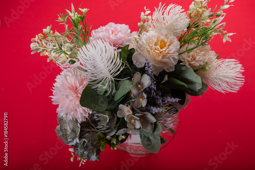 Minimal floral arrangement on red surface