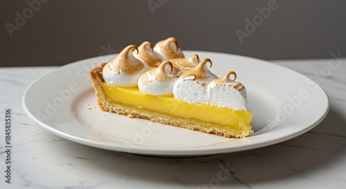 Close-up view of a freshly baked, glossy lemon meringue tart slice resting on a white plate, ready for serving, rustic, tart, elegant