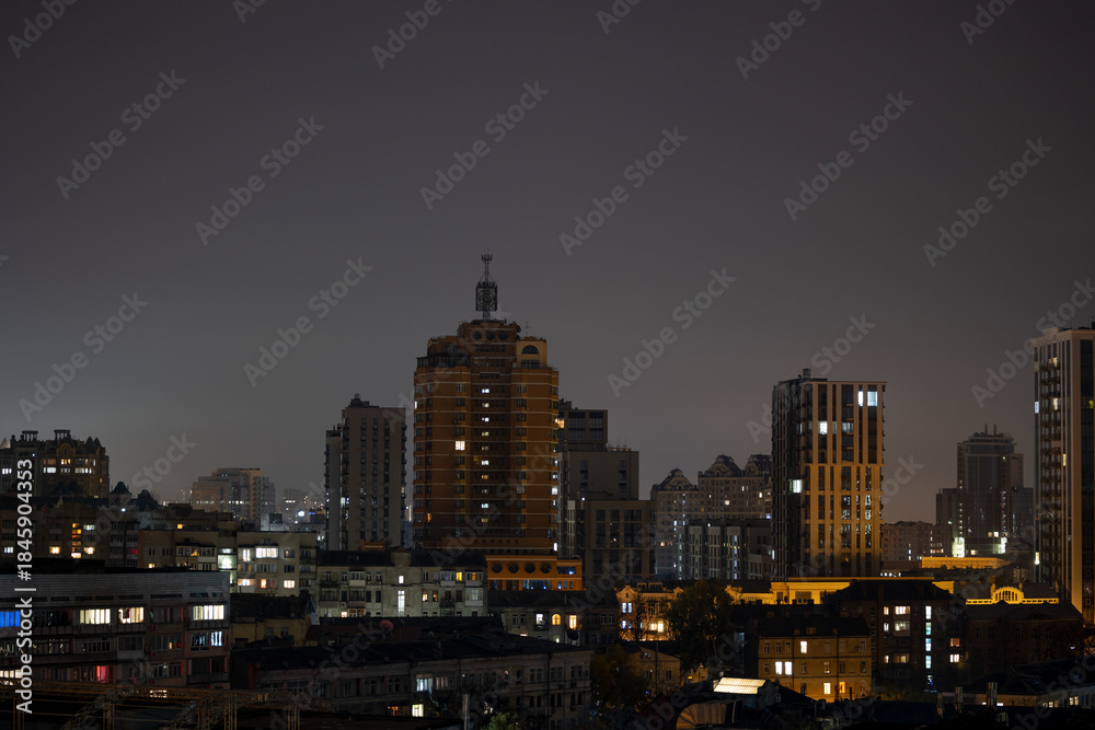 Obraz premium Illuminated residential districts under dark night sky