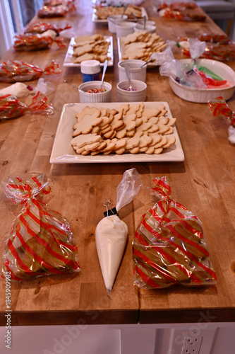 Homemade Christmas sugar cookies set up for themed Daddy Daughter cookie decorating holiday party with sprinkles, icing and coloured sugar