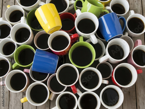 Assorted coffee mugs on wooden surface