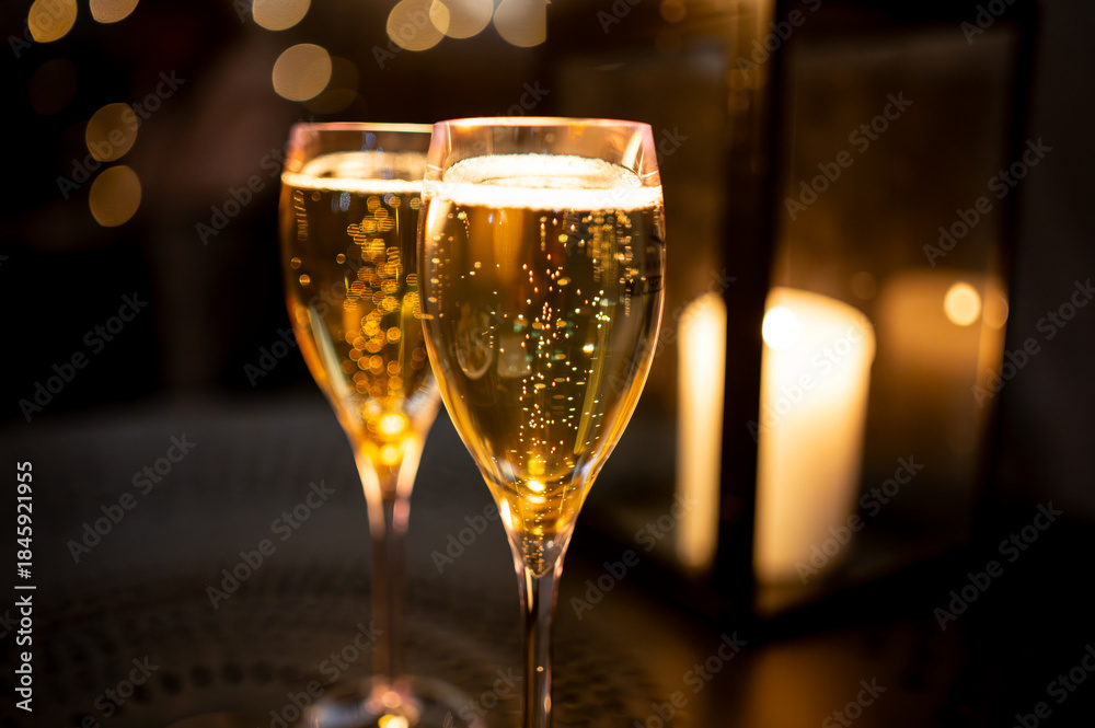 Fototapeta premium Two glasses of french sparkling wine champagne with little bubbles, New Year celebration, wedding or champagne tour with visit of caves, Reims, France