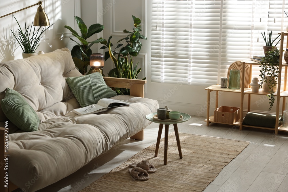 Obraz premium Stylish living room with sofa and houseplants. Interior design