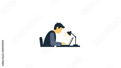 Man working on laptop computer under desk lamp.