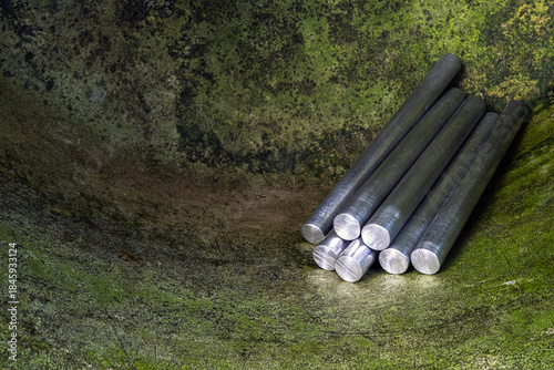 Aluminum rods in a patinated industrial space, products of the metallurgical industry