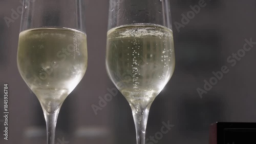 Two Champagne Flutes With Bubbles On Dim Bar Counter Pale Golden Sparkling Wine In Elegant Glass Flutes, Rising Effervescence, Soft