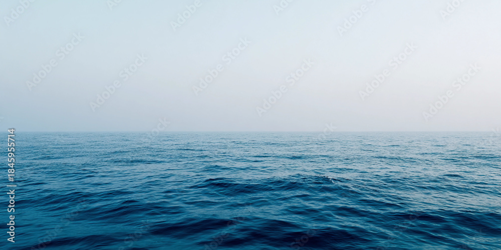 Fototapeta premium Calm ocean horizon with gentle waves under a soft, minimalist sky Generative AI