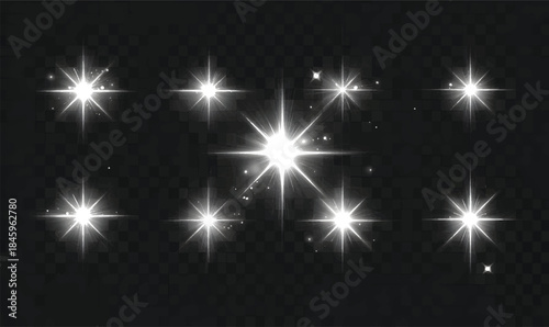 Set of glowing light effects with white flares and stars on a black background