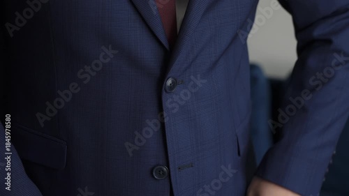 Closeup Of Man Fixing Tie In Formal Suit, Close View Of Professional Adjusting His Tie While Dressed In Navy Suit Jacket