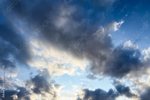 Atmospheric blue sky background with soft glowing clouds and copy space