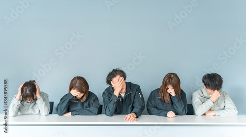 Photos A businessman and woman in work clothes holding their heads